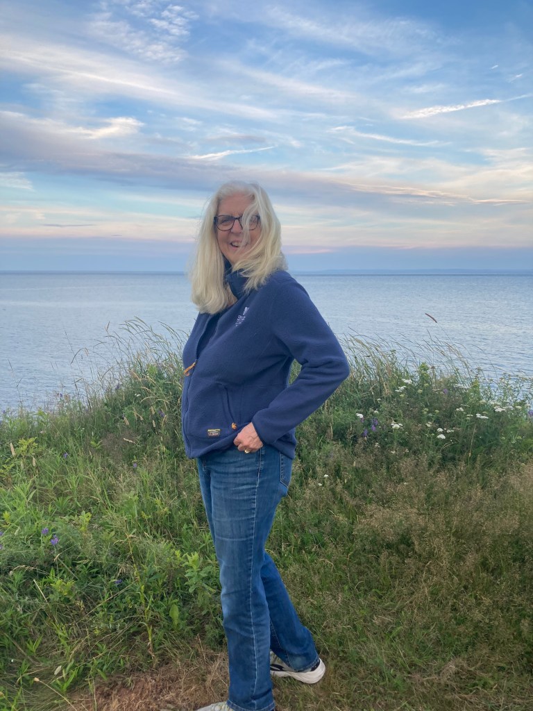 Woman standing by the sea.
